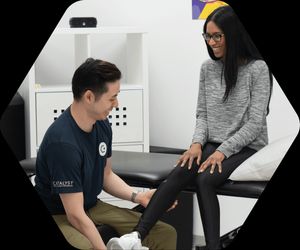 Vince taping a patient's ankle